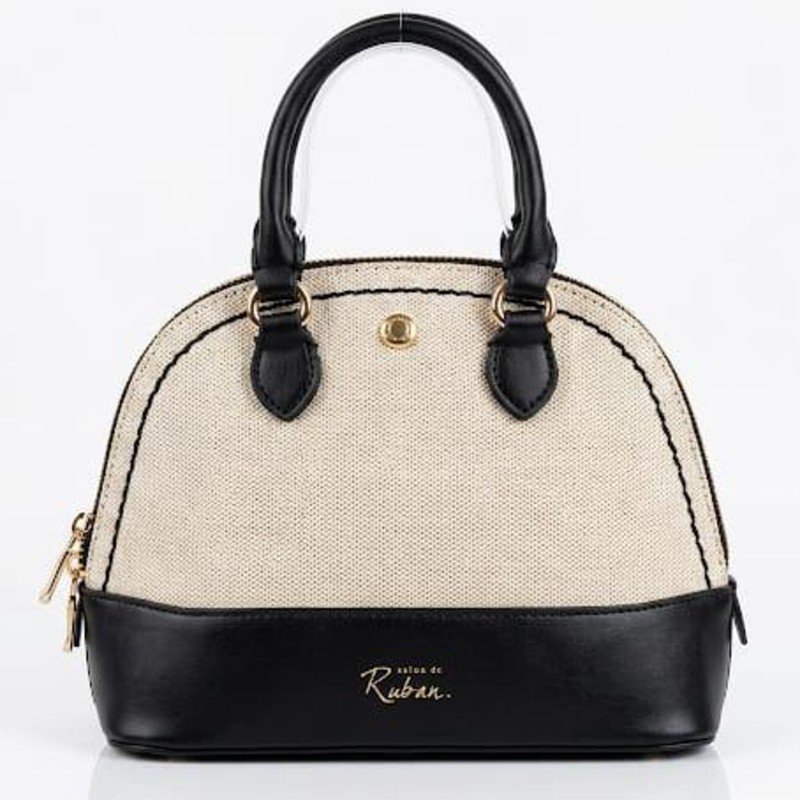 Salon de Ruban dome-shaped handbag featuring a beige fabric upper section and a black leatherette base.
