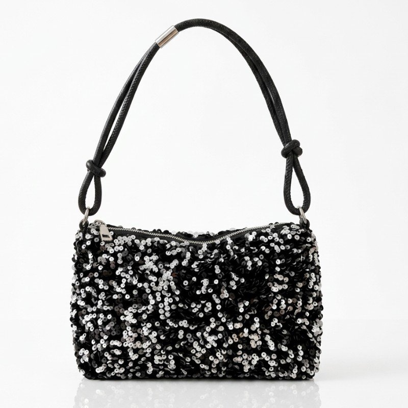 Black and silver sequin handbag featuring a single top handle with knotted details.
