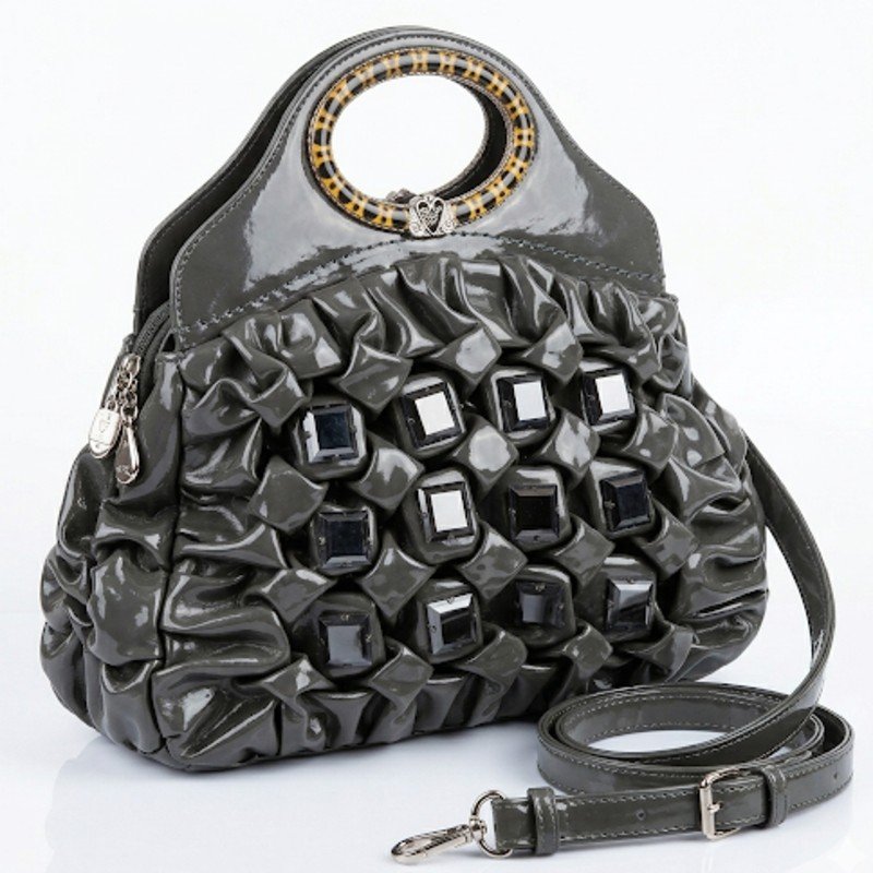 Grey patent leather handbag with quilted texture and dark stone embellishments.