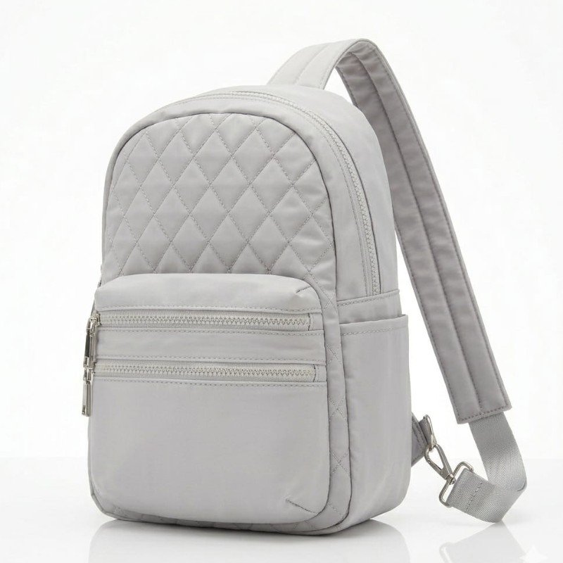 Grey nylon mini backpack with a quilted front panel and zipper pockets