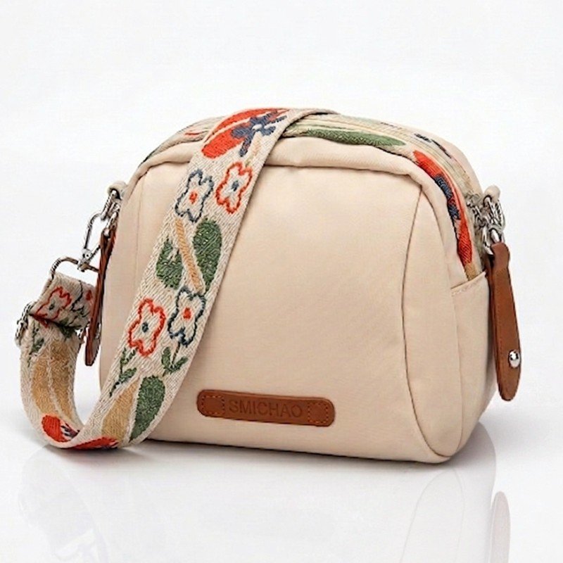 Smichao nylon crossbody shell bag with a floral wide strap and zipper closure.