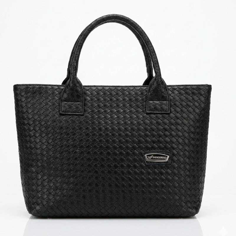 black woven faux leather tote bag with a branded metal plaque