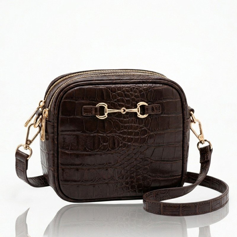 brown croc-embossed synthetic leather crossbody bag featuring gold hardware and a horsebit detail.