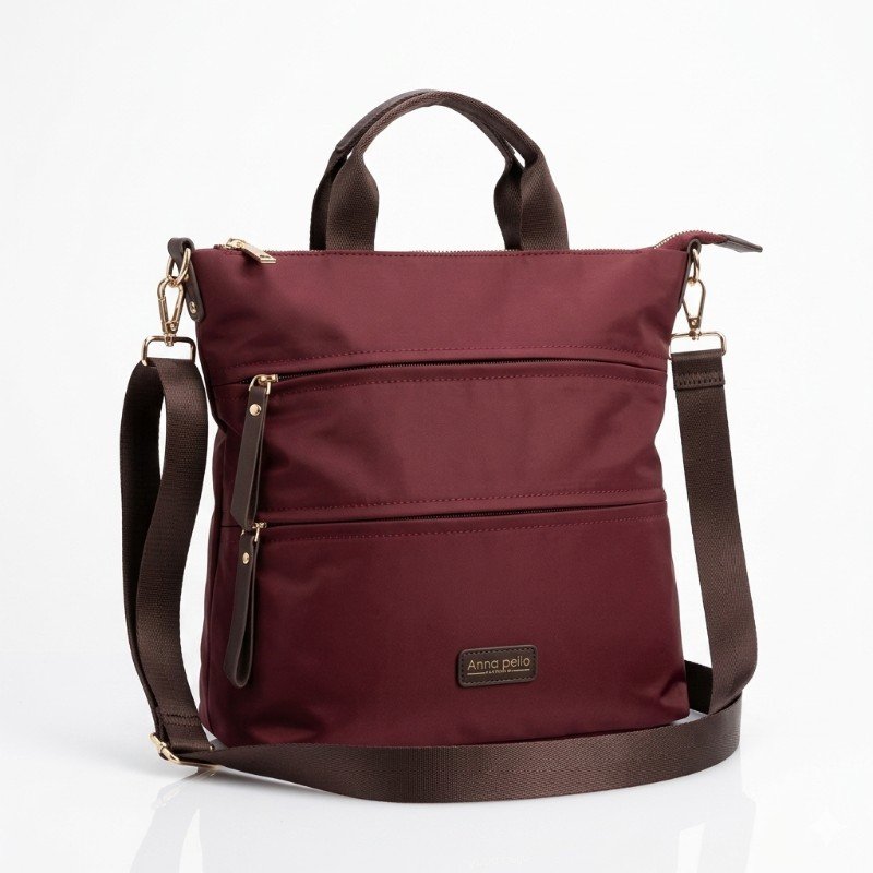 Anna Peilo bag features a durable nylon construction in a deep maroon color with multiple exterior zip pockets for organization