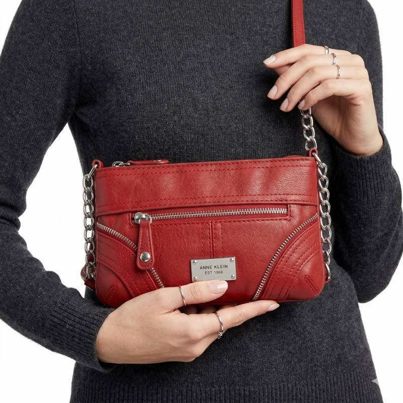 Anne Klein red crossbody bag with silver-tone chain straps and zipper details. view 2