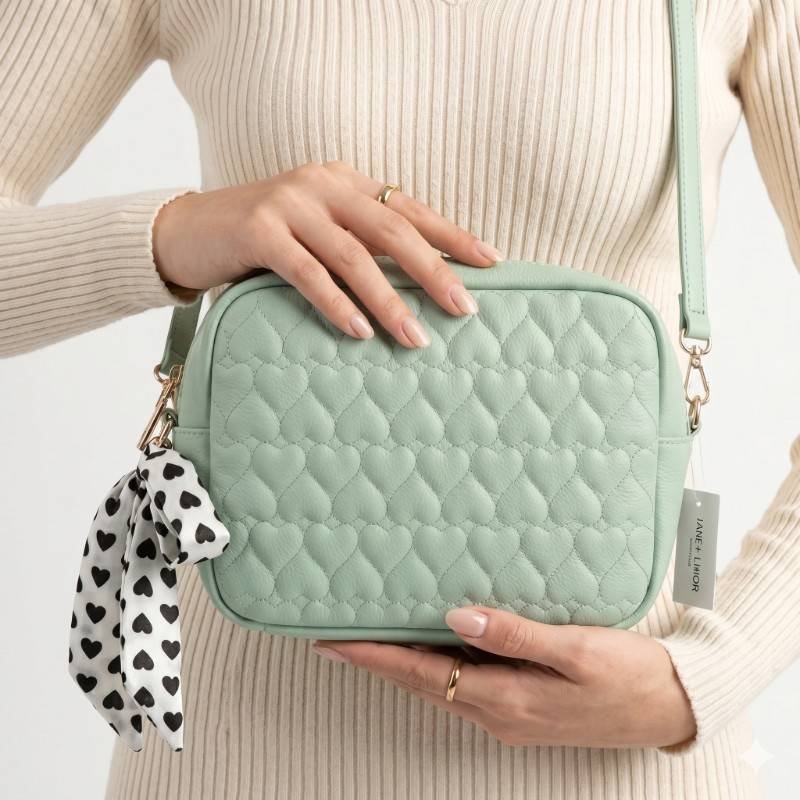 reen cross-body bag from Daraz features a quilted heart pattern and an attached black and white patterned scarf. - view 2