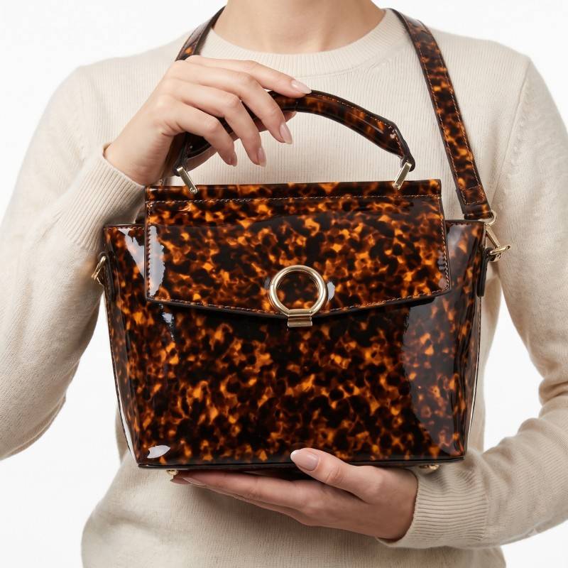 Just fab Tatum small satchel handbag features a glossy tortoiseshell patent finish view 2